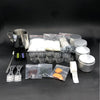 A complete candle making kit showing a pouring pot, wicks, fixator, and various materials on a dark surface.
