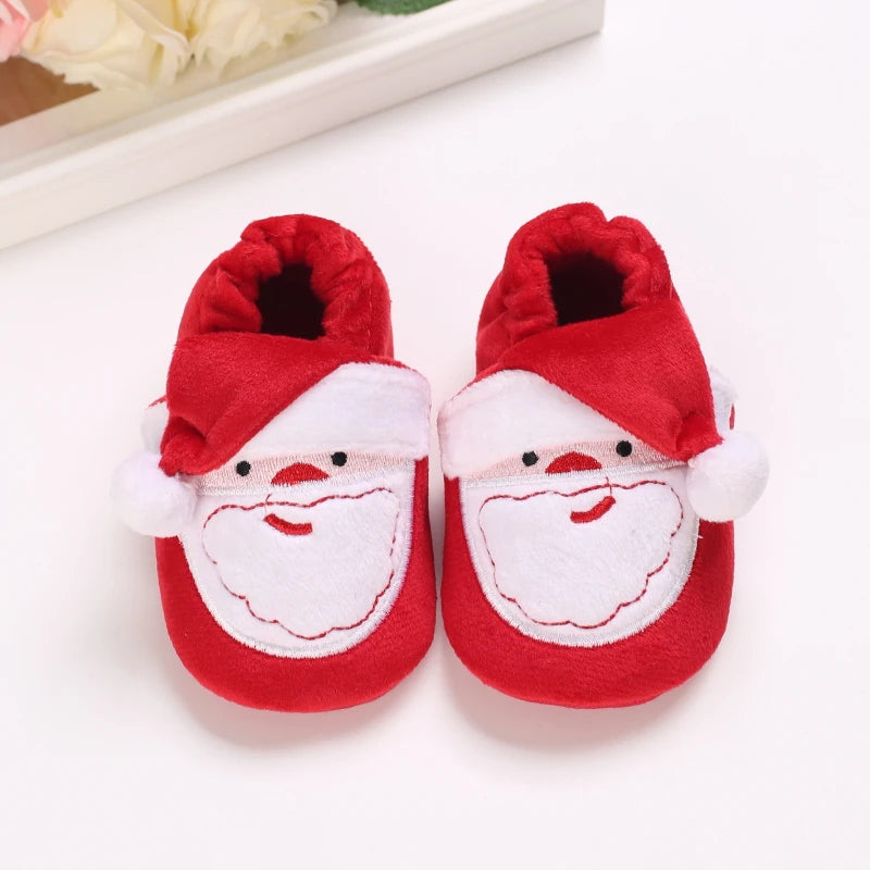 A pair of red and white plush baby winter boots designed for first walkers.