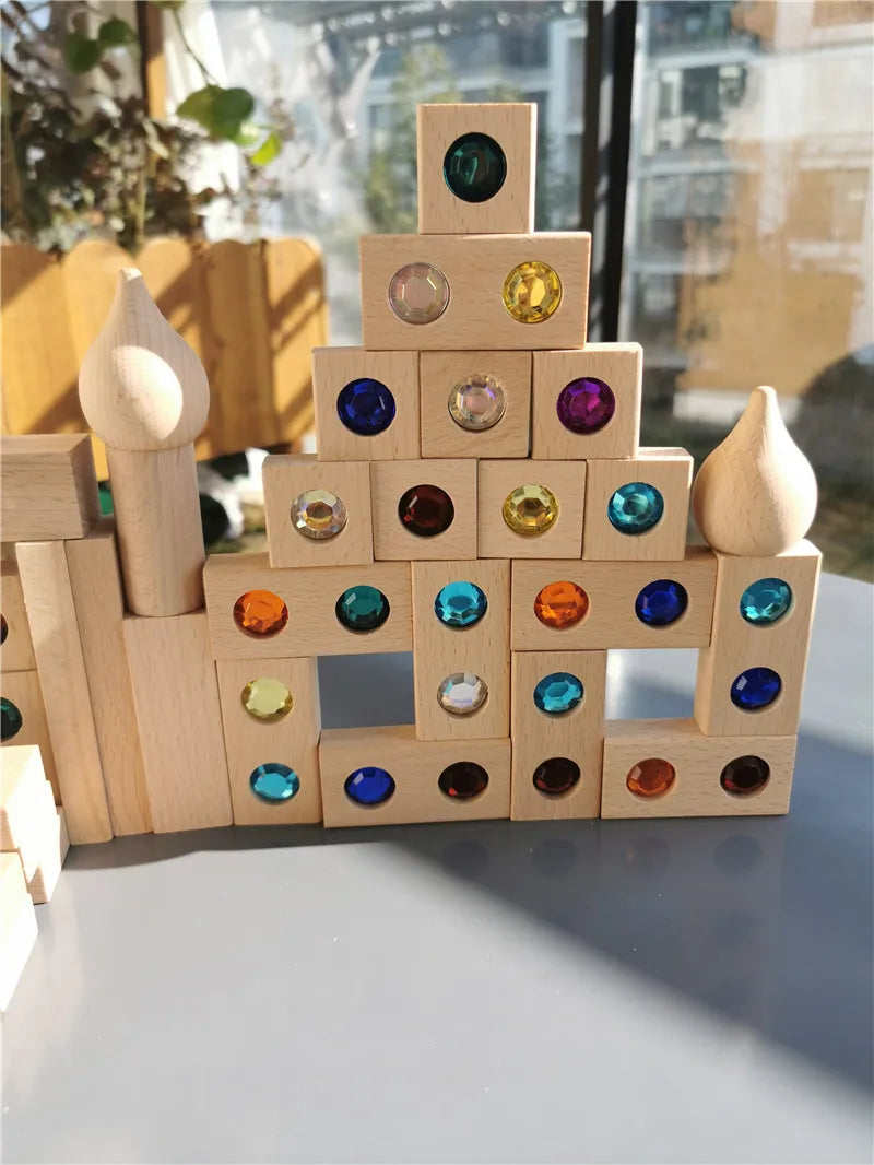 A stack of wooden gemstone building blocks featuring various colored acrylic crystals.