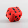 A red plush toy shaped like a die with black polka dots.
