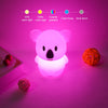 A white koala-shaped LED night light glows pink on a surface, with a color gradient indicator bar above it.