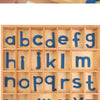 A wooden alphabet box with letter cards showing the lowercase and uppercase letters of the English alphabet.