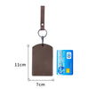 A brown leather key wallet with a card holder attached to a strap and a keyring.