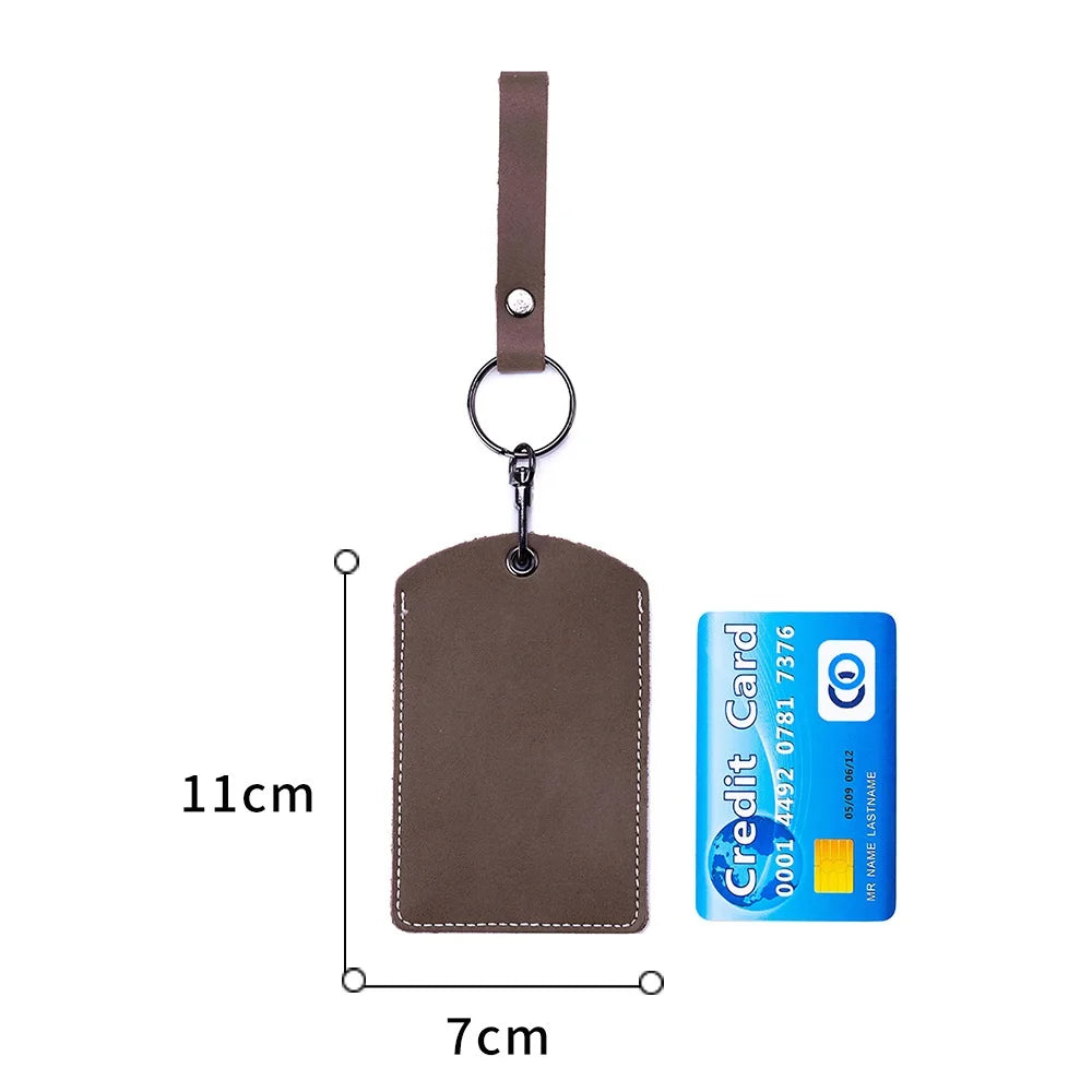 A brown leather key wallet with a card holder attached to a strap and a keyring.