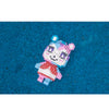 A small, colorful building block figure resembling a stylized animal character built from pink and purple bricks on a blue su