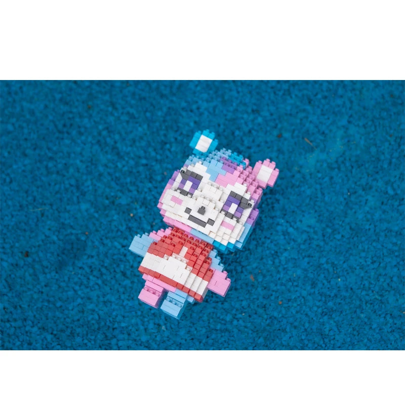 A small, colorful building block figure resembling a stylized animal character built from pink and purple bricks on a blue su