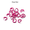 A collection of pink rose red metal open jump rings for DIY jewelry making.