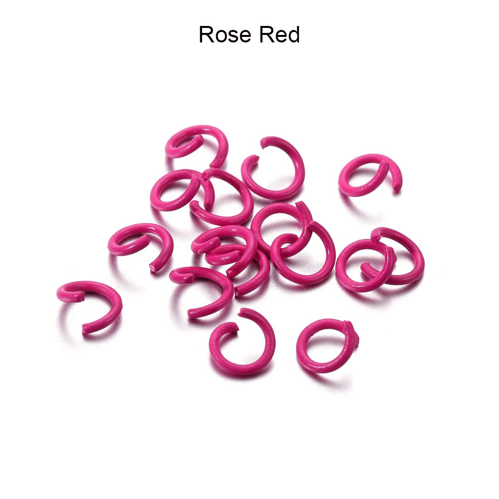 A collection of pink rose red metal open jump rings for DIY jewelry making.