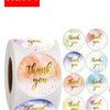 A roll of white paper with watercolor designs featuring 'thank you' in various colors like pink, orange, and blue.