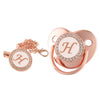 Rose gold bling baby pacifier clip featuring a silicone holder and a decorative heart design
