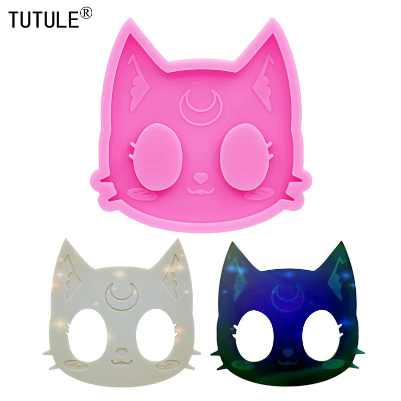 Pink silicone cat head molds for DIY keychains and craft projects shown with finished purple and white cat masks