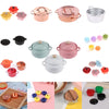 A collection of miniature copper and silver soup pots and accessories for a dollhouse kitchen.