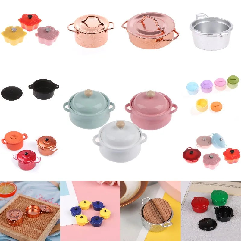 A collection of miniature copper and silver soup pots and accessories for a dollhouse kitchen.