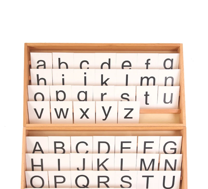 A wooden alphabet box containing individual letter cards for learning.