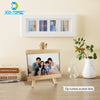 A mini wooden chalkboard easel displaying a family photo on a light wood surface.