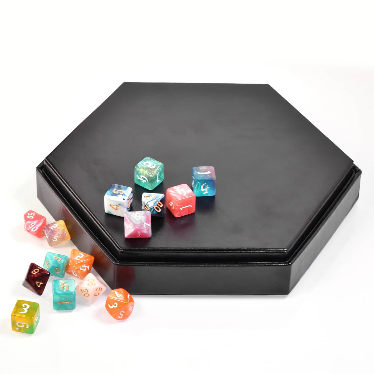 A black hexagonal storage box containing various colored dice and a small velvet interior.