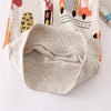 A close-up of a light beige kids' pullover sweatshirt featuring a colorful dinosaur print.