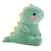 A soft, light green dinosaur plush toy with yellow spikes and a pink nose.