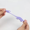 A hand holds a purple stretchy rubber chicken slingshot fidget toy with a curved beak and body.