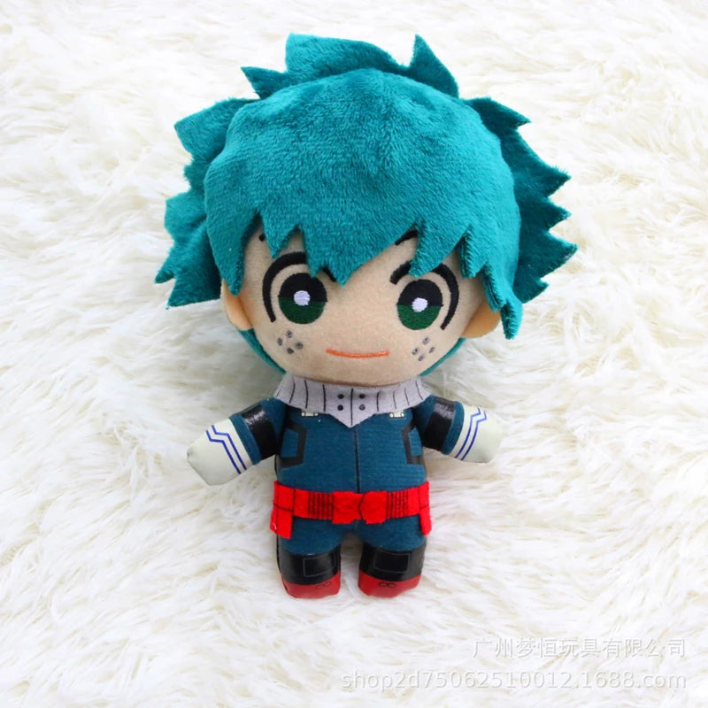 A teal-haired anime plush figure with large eyes and a blue outfit resting on a white fluffy surface.