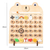 A wooden daily calendar board showing the month of August, days 1 through 31, and various icons for weather and activities.