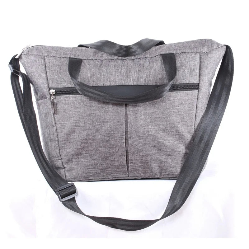 Gray stroller accessory kit featuring a mosquito net and rain cover attached to a fabric pouch.