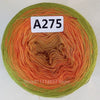 A ball of rainbow gradient mercerized cotton cake yarn showing various shades of orange, green, and yellow fibers.