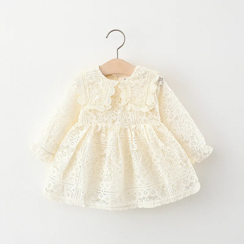 A cream-colored lace princess dress for a toddler girl with a doll collar, displayed on a wooden hanger.