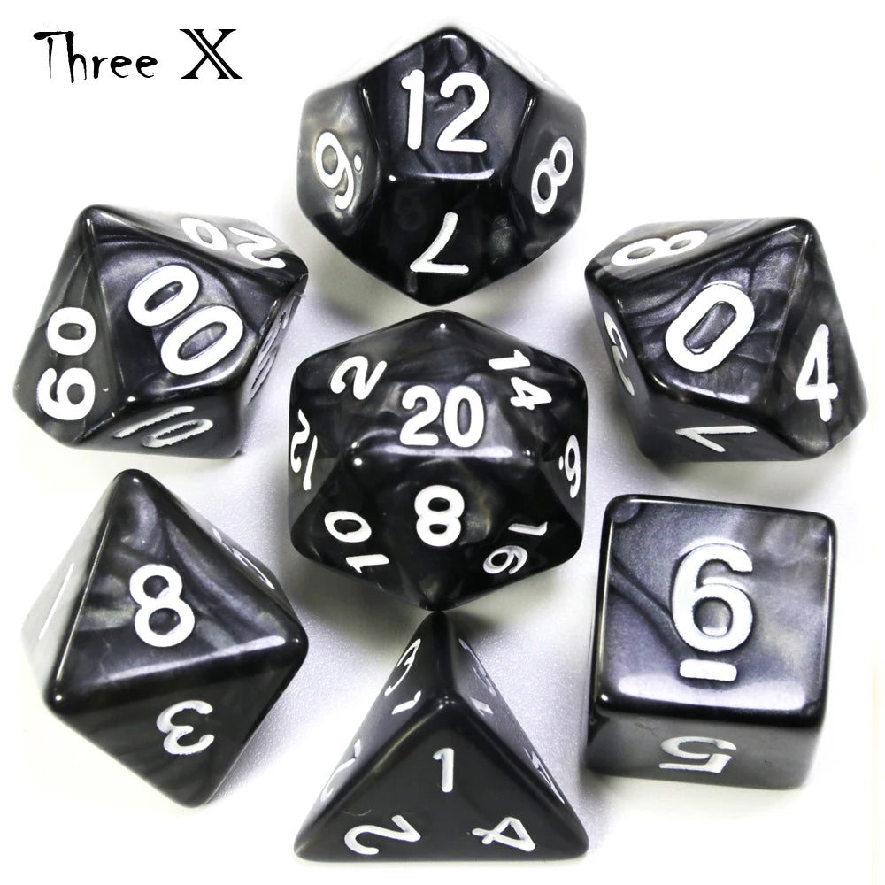 A set of black polyhedral dice including a d12, d6, d8, d10, and d20.
