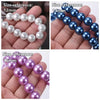 Three sets of imitation pearl beads in white, blue, and purple colors shown on a hand for size reference.