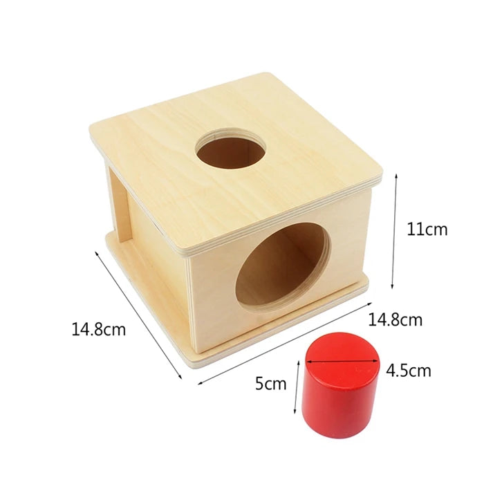 A wooden sensory toy set featuring a cube with holes and a red cylinder.