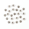 A collection of small, silver-toned Tibetan style hollow flower bead caps for jewelry making.