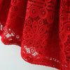 A close-up of a red lace princess dress for a toddler girl with a doll collar.