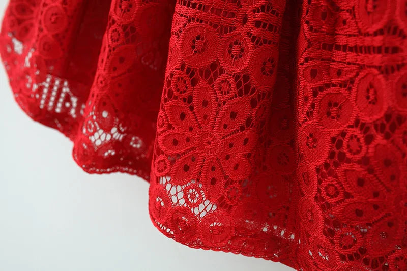 A close-up of a red lace princess dress for a toddler girl with a doll collar.
