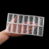 A hand holds a clear silicone mold set for dominoes used in epoxy resin jewelry making