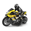 A black and yellow 1:10 scale remote control stunt motorcycle with a rider in full gear.