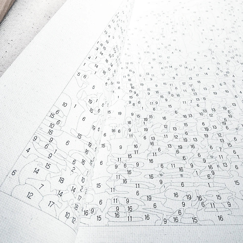 A close-up view of a paint by numbers kit for adults featuring a detailed flower design on canvas.