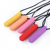 A set of silicone chew necklaces in yellow, orange, pink, and red are displayed against a white background.