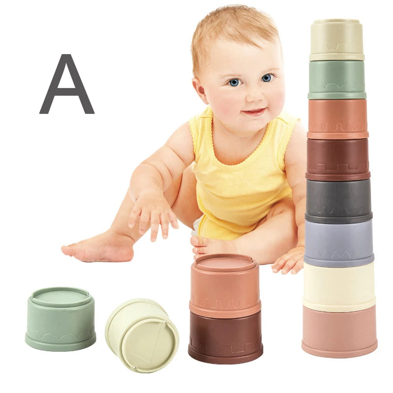 A baby is shown with a set of boat-shaped stacking cups in various colors like green, beige, and brown.