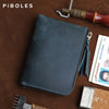 A dark blue leather coin purse with a zipper is shown resting on a brown surface next to a knife and a driver license.