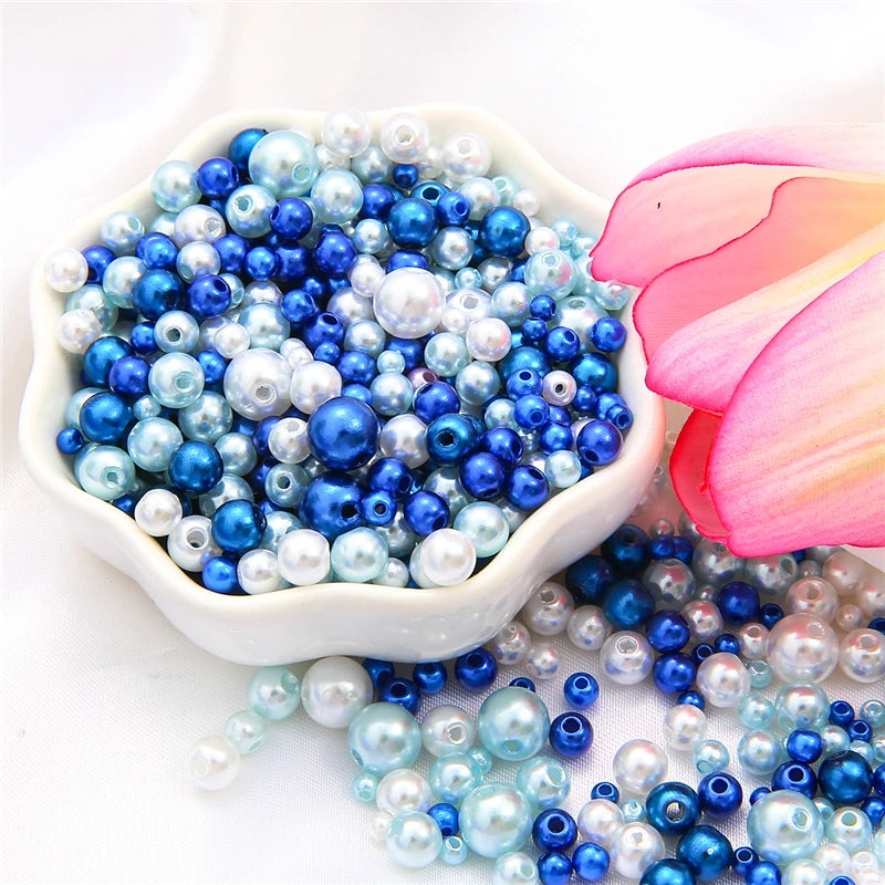 A bowl filled with assorted blue and white pearl beads for jewelry making.