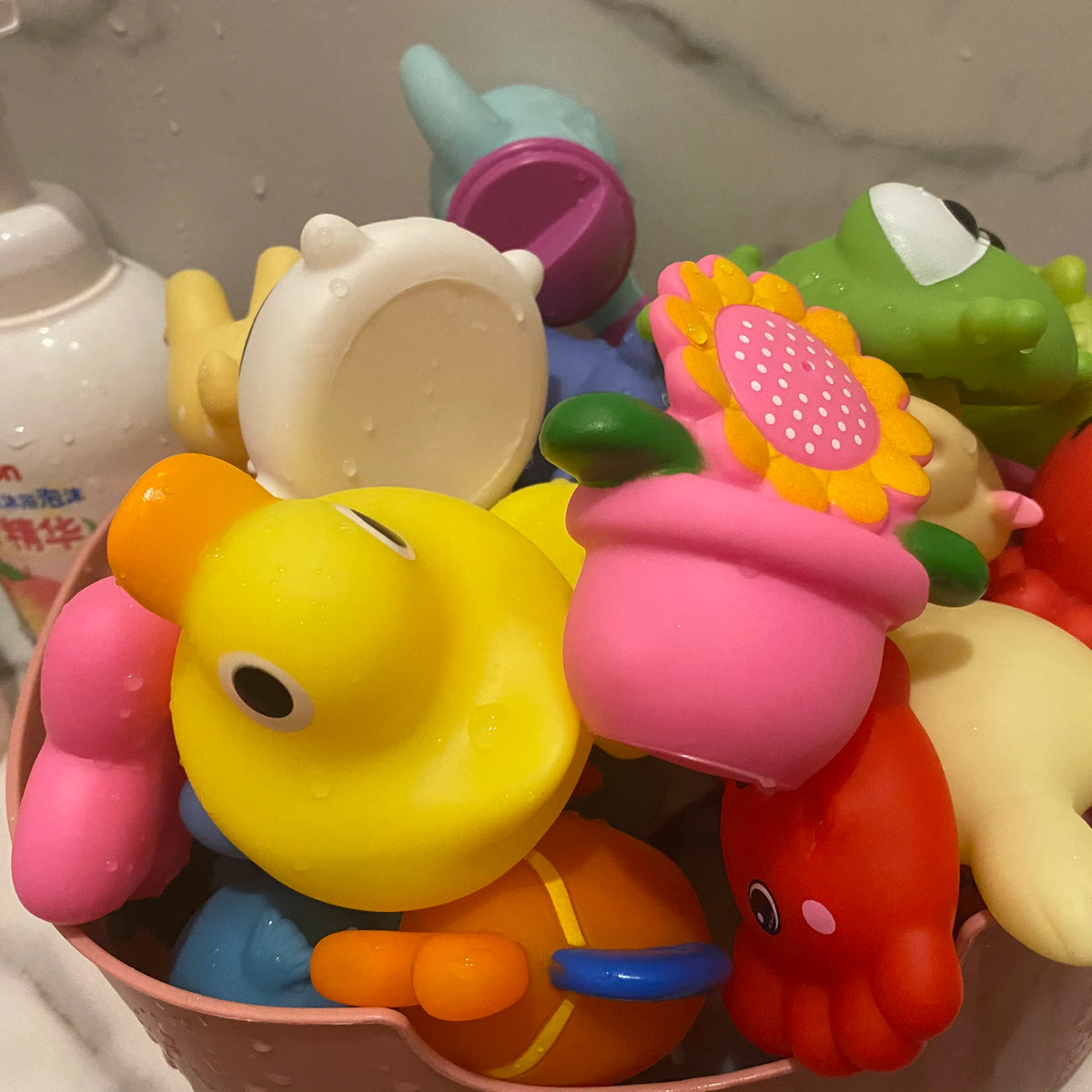 A collection of colorful cartoon soft rubber bath toys featuring various vehicle and animal designs.