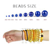 A display of round blue spacer beads in various sizes ranging from 3mm to 16mm, shown next to a hand wearing multiple strands