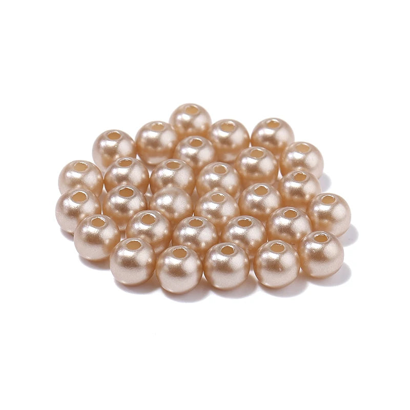 A cluster of small, pale pink imitation pearl beads for DIY jewelry making.