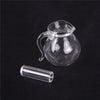 A clear glass miniature alloy kettle with a handle is shown next to a small cylindrical glass tube.