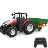 A black and red remote control tractor with a green trailer is shown.