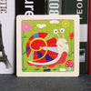 A wooden tangram puzzle featuring a colorful animal design on a green background.