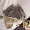 A beige kids cotton pullover sweatshirt with black horizontal stripes is displayed on a white background.
