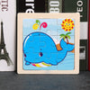 A wooden jigsaw puzzle featuring a blue whale and a sun design.