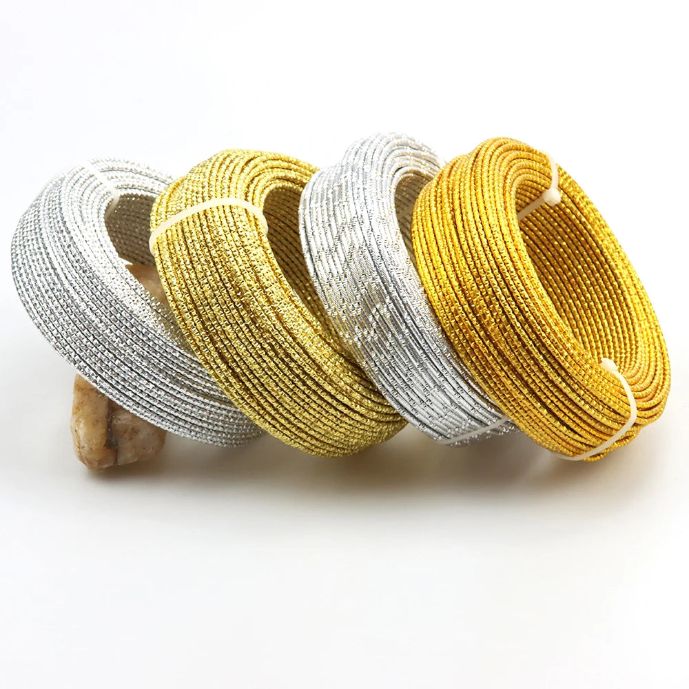 A collection of flexible aluminum craft wire in silver and gold colors coiled together.